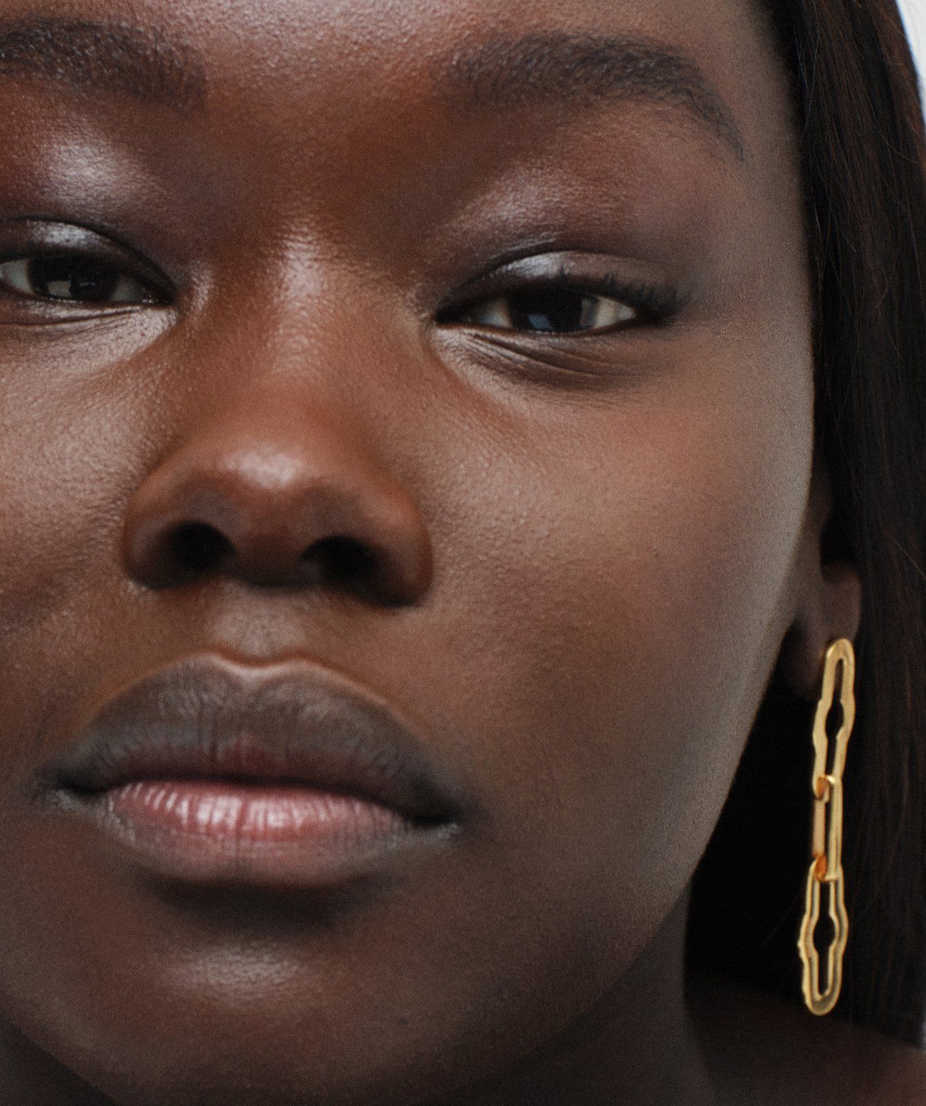 Model wearing Mulberry Pimlico chain earring in gold